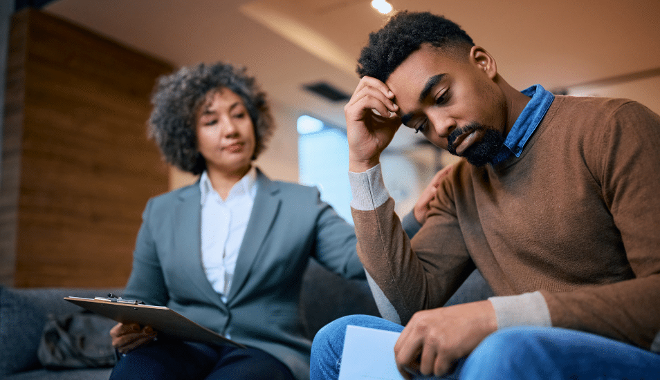 Worried African American man having a meeting with financial advisor in the office.