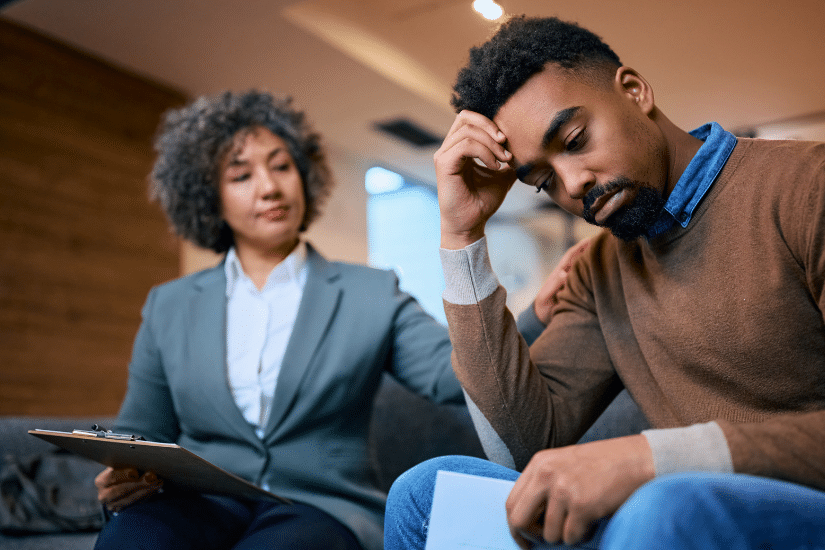 Worried African American man having a meeting with financial advisor in the office.