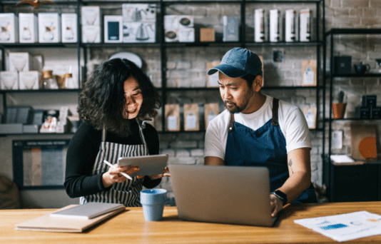 The owners of this coffee shop engage in a lively discussion, exchanging ideas and making plans for the business.