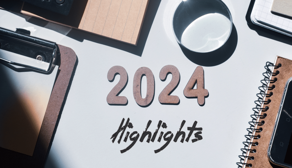 2024 highlights written in wooden letters and inscription on an office desk background.