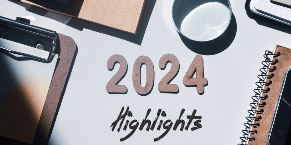 2024 highlights written in wooden letters and inscription on an office desk background.