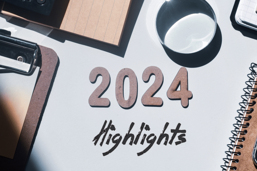 2024 highlights written in wooden letters and inscription on an office desk background.