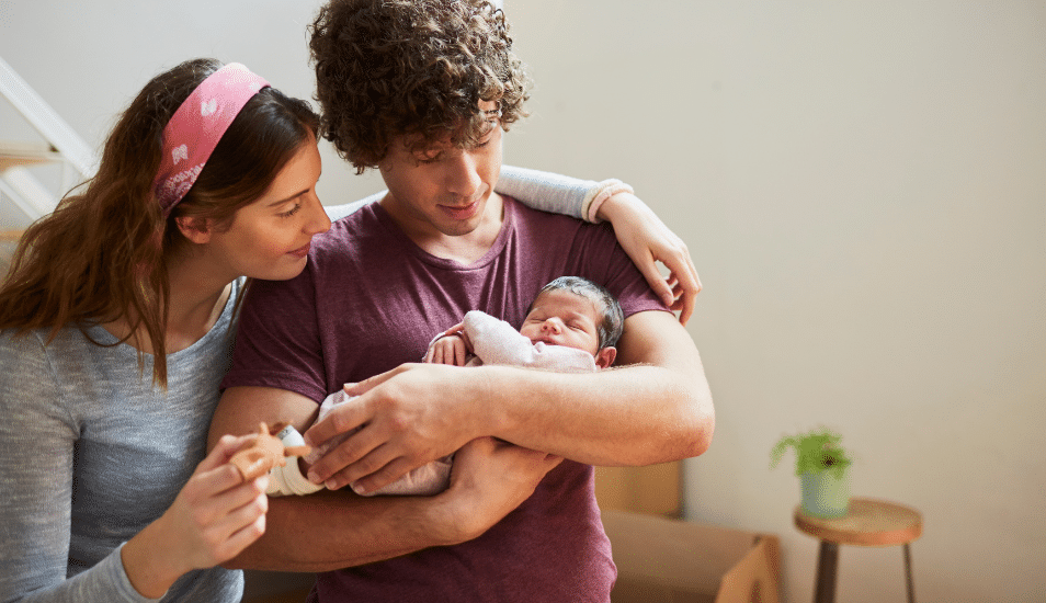 Parents holding their new born baby.