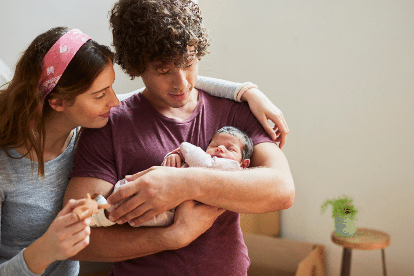 Parents holding their new born baby.