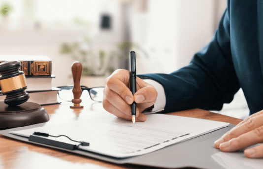 Legal employee working in the office signing documents.