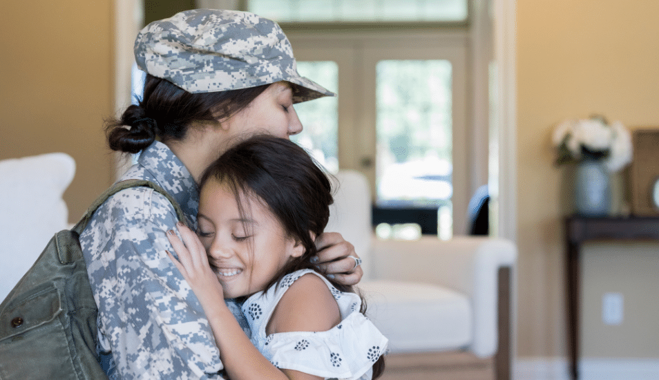 A young girl is happy to see army mom.