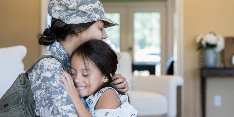 A young girl is happy to see army mom.