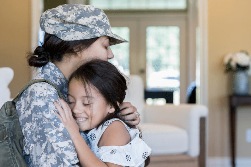 A young girl is happy to see army mom.