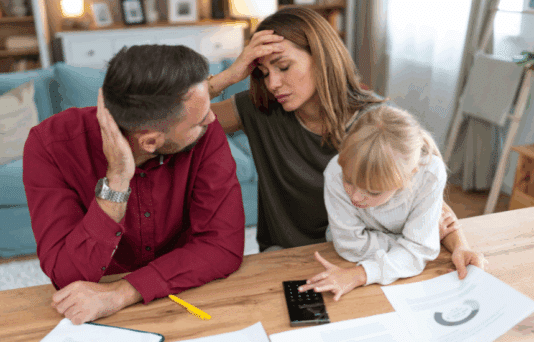 Young family with a daughter feeling stressed managing budget and paying bills and taxes
