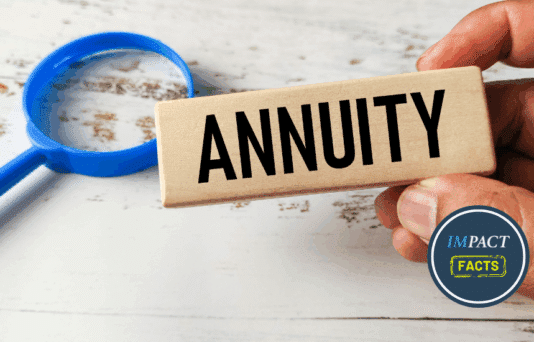 Hand Holding a Wooden Block Engraved with Annuity Next to a Magnifying Glass.