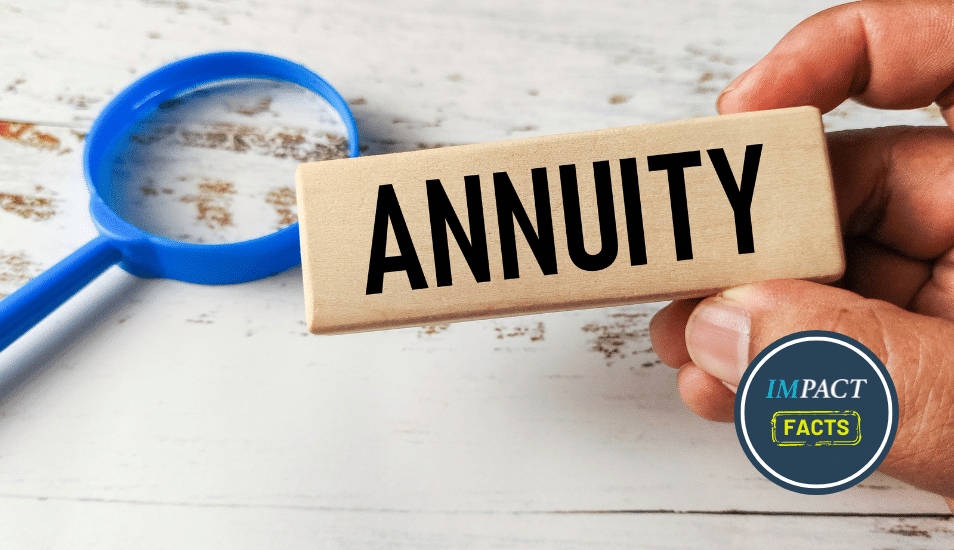 Hand Holding a Wooden Block Engraved with Annuity Next to a Magnifying Glass.