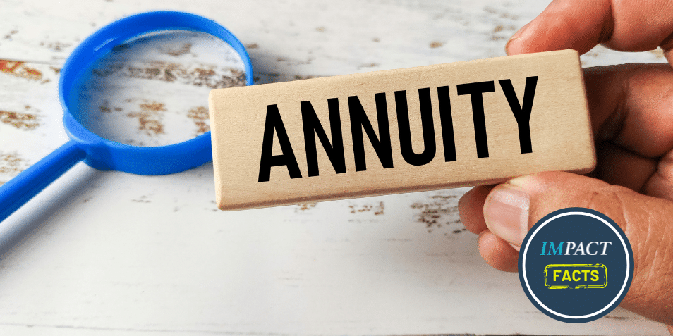 Hand Holding a Wooden Block Engraved with Annuity Next to a Magnifying Glass.