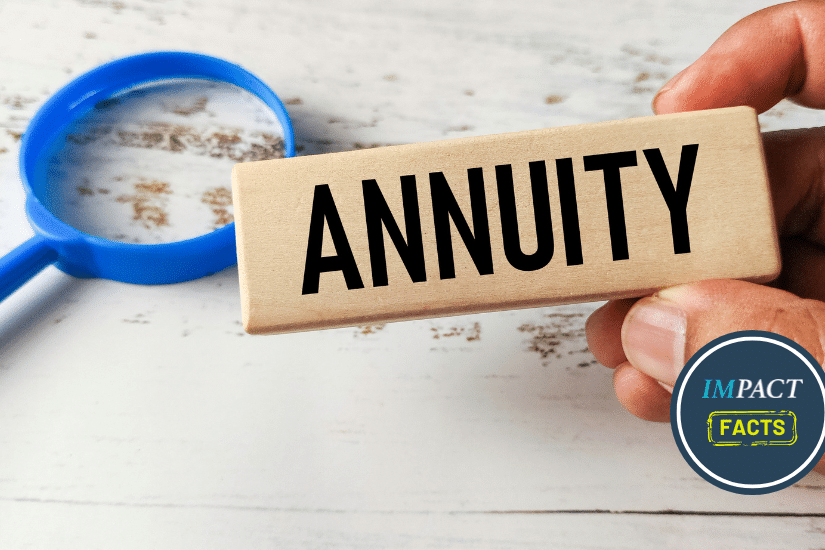 Hand Holding a Wooden Block Engraved with Annuity Next to a Magnifying Glass.
