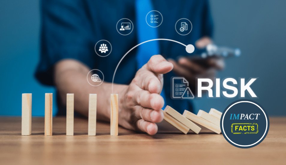 Businessman stops falling dominoes with hand, showing risk prevention.