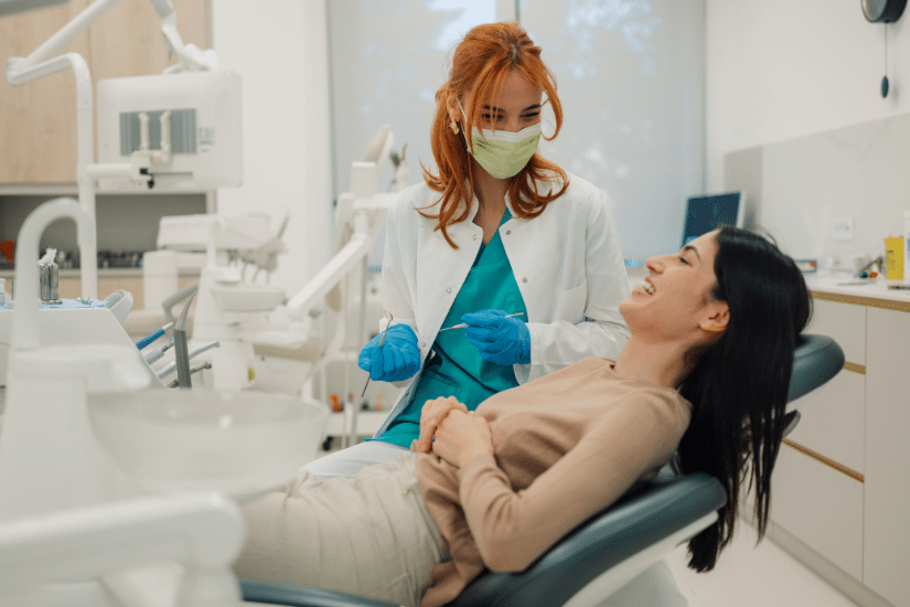 Dentist talking with her patient in dental clinic.