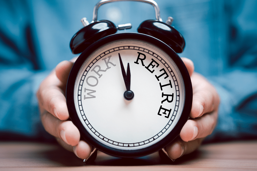 Businessman holding black alarm clock with clockwise countdown from work to retirement.