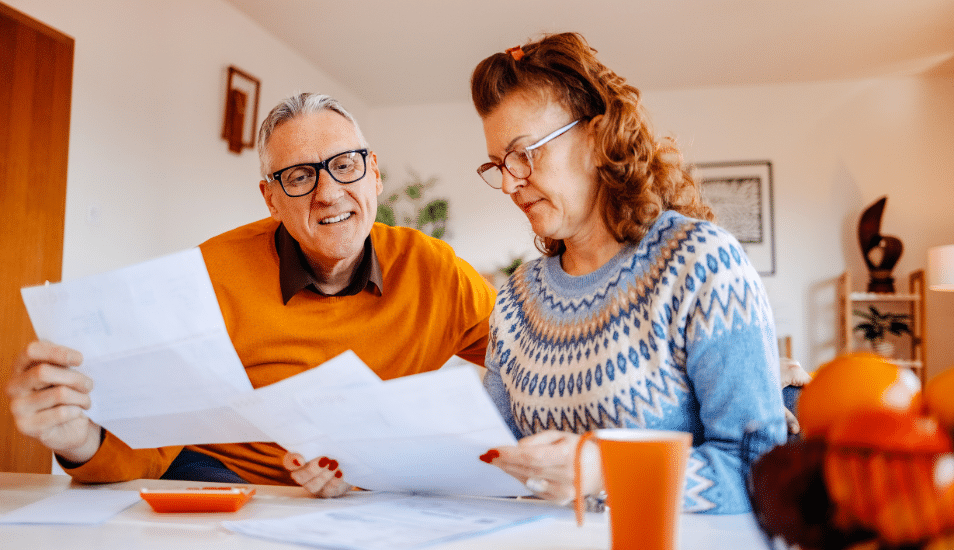 Mature adults spending time enjoying at home working on home finances together.