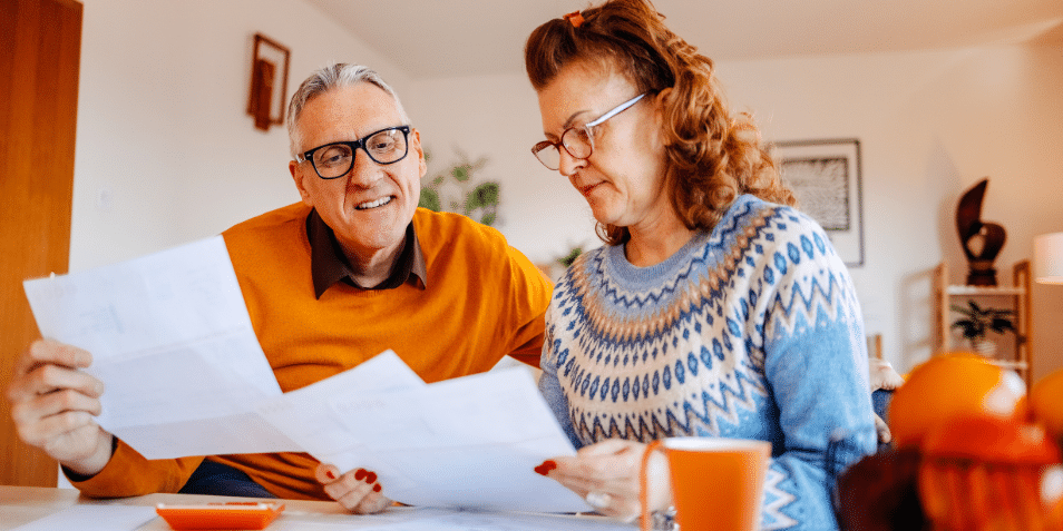 Mature adults spending time enjoying at home working on home finances together.