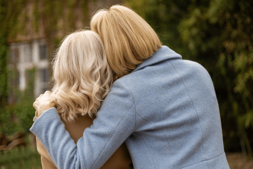 The back of two women embracing.