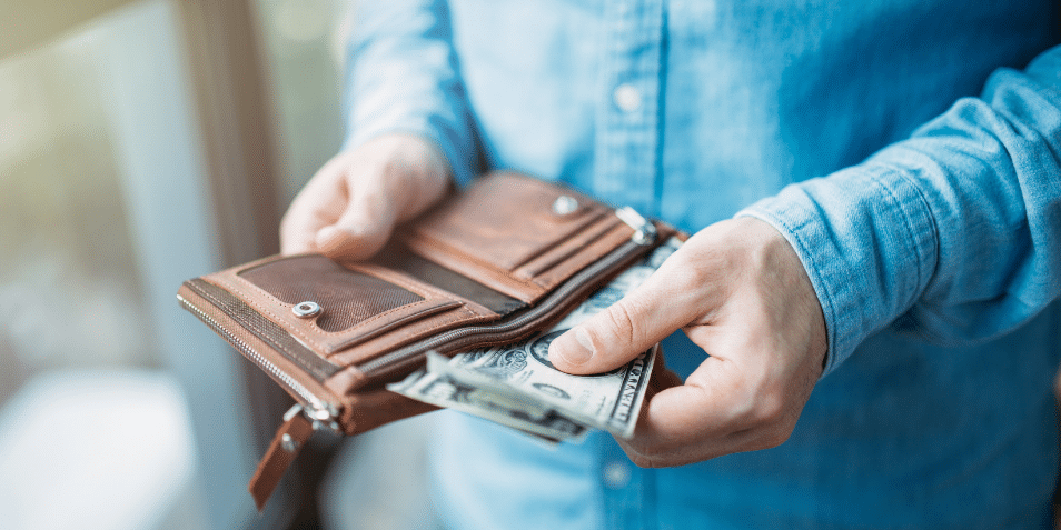 A person pulling out cash from their wallet.